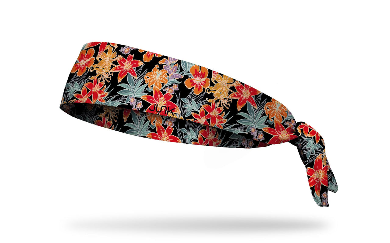 black headband with tropical floral print in green orange red and yellow