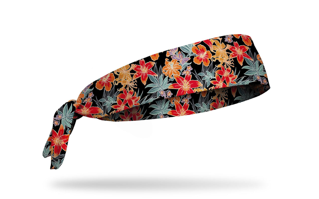 black headband with tropical floral print in green orange red and yellow