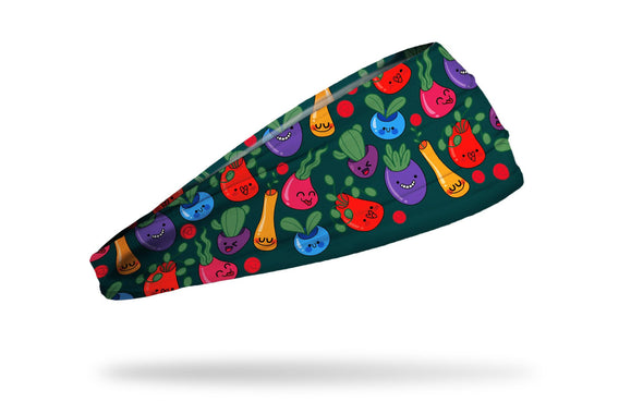 green headband with repeating pattern of plants with happy smiley faces