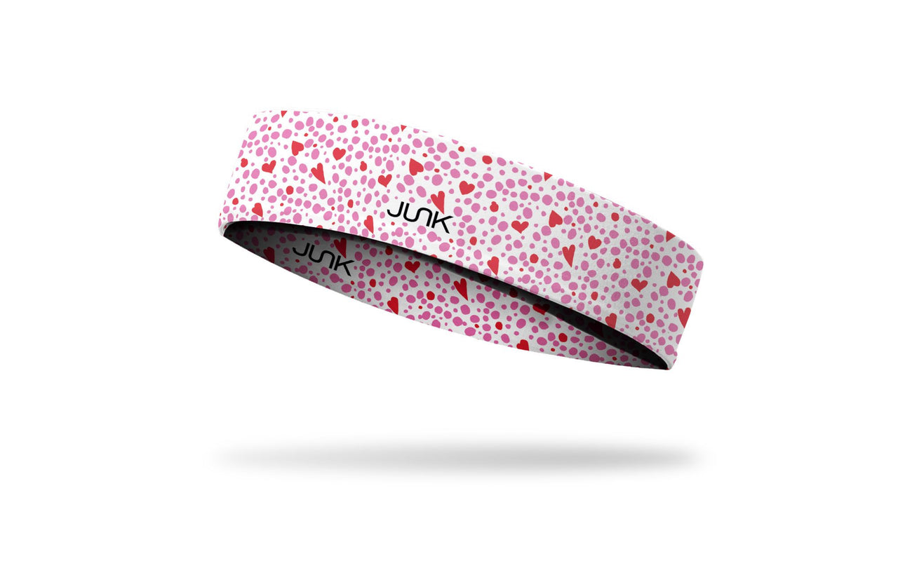 white headband with repeating pattern of dots and hearts in pink and red