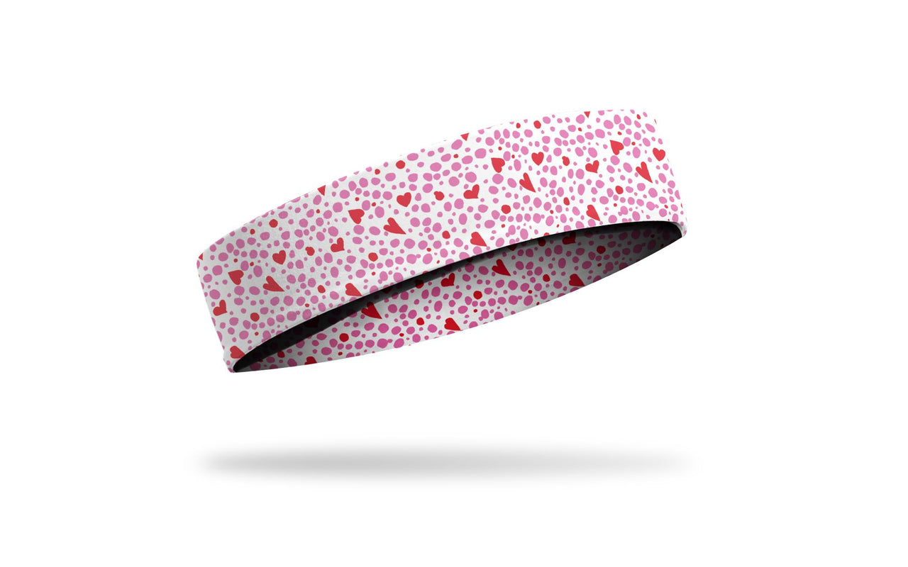 white headband with repeating pattern of dots and hearts in pink and red