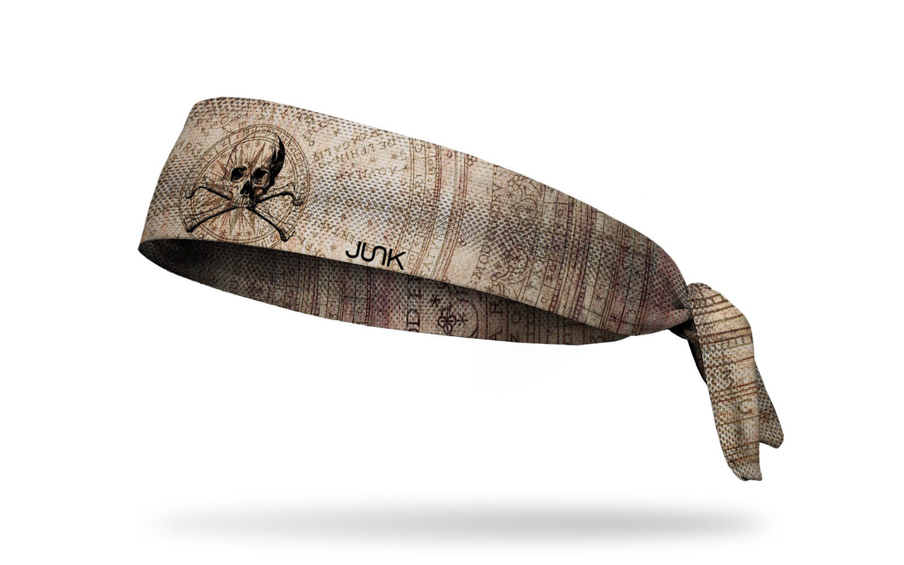 faded khaki headband with map design and skull and crossbones in middle