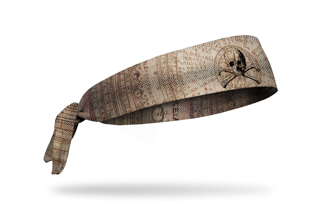 faded khaki headband with map design and skull and crossbones in middle