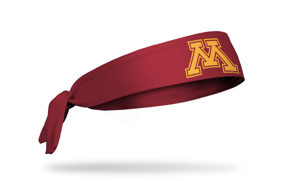 maroon headband with University of Minnesota m logo in gold
