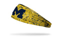 yellow gold headband with paint splatter and University of Michigan logo