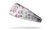 white headband with delicate floral outline and splashes of yellow pink and blue