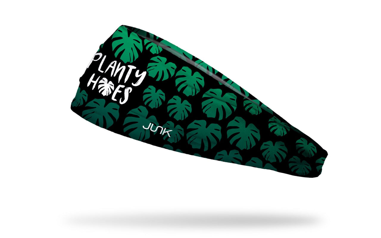 black headband with repeating pattern of elephant ear tropical leaves and planty hoes saying