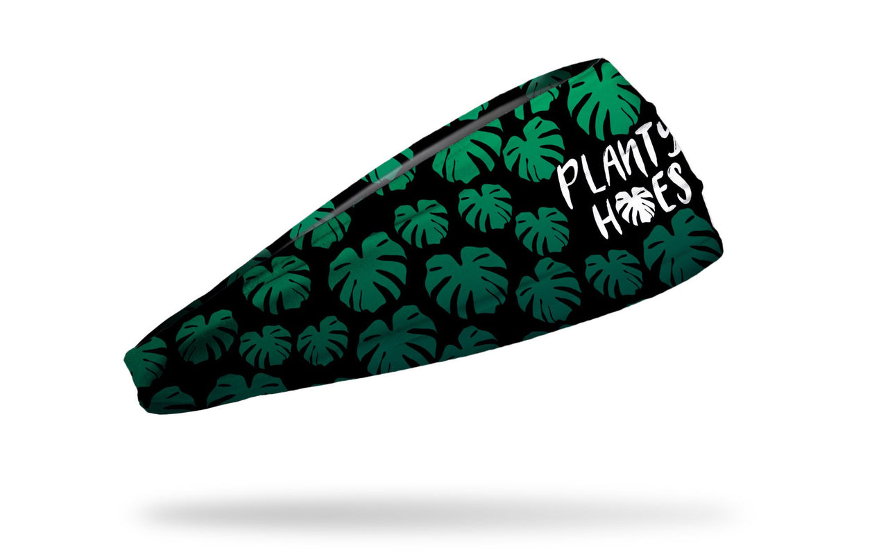 black headband with repeating pattern of elephant ear tropical leaves and planty hoes saying
