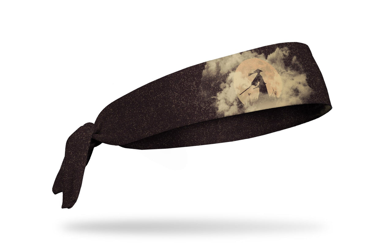 grey headband with drawn scene of a samurai standing with the sun at their back