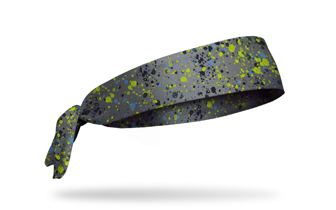 light grey headband with green blue and black paint splatters