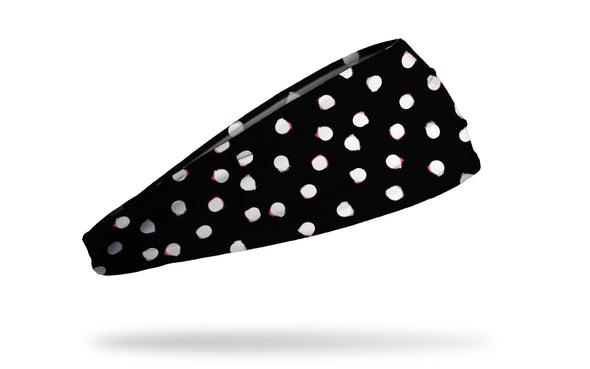 black headband with white dots that have been smudged to look like color bleed