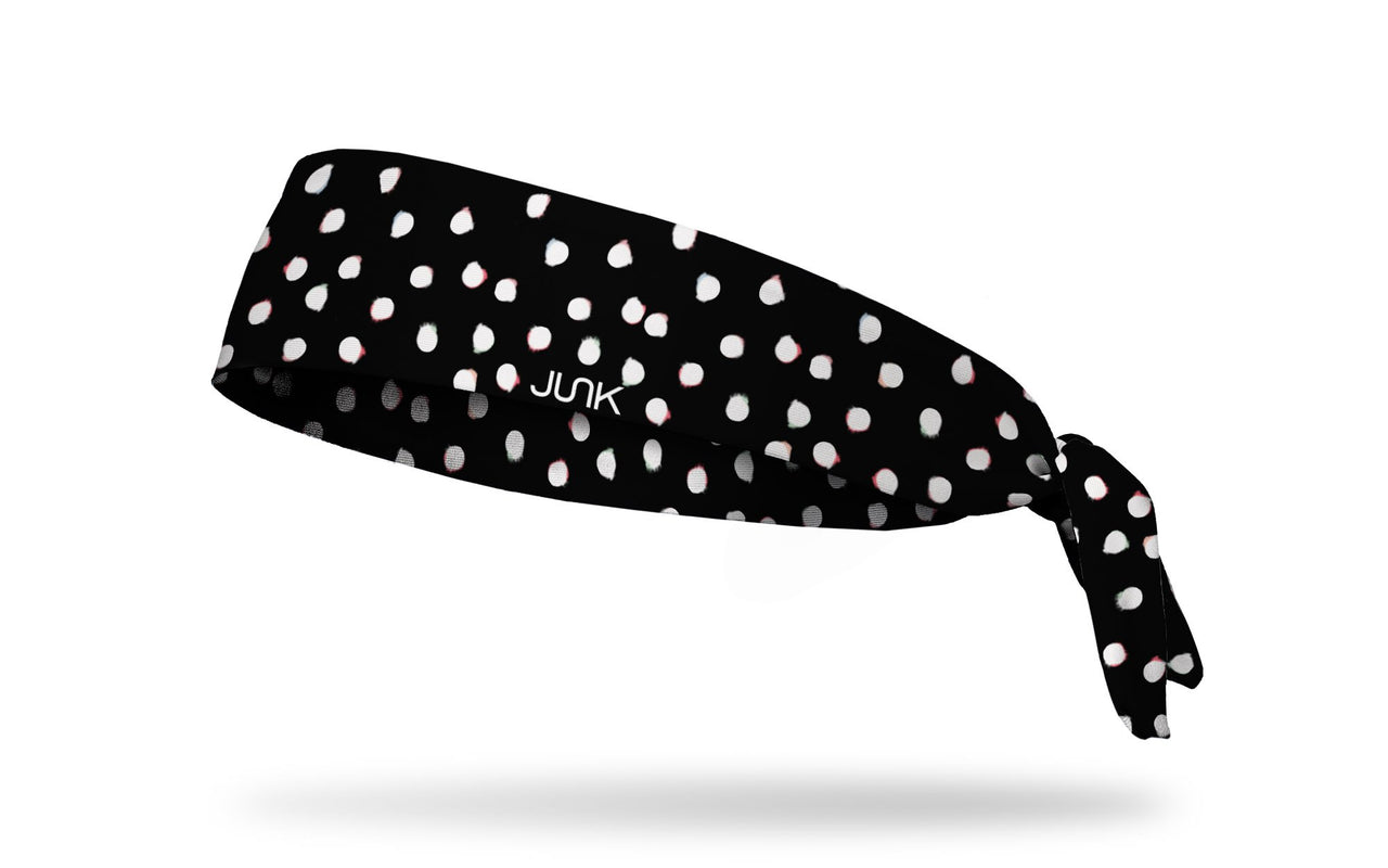 black headband with white dots that have been smudged to look like color bleed