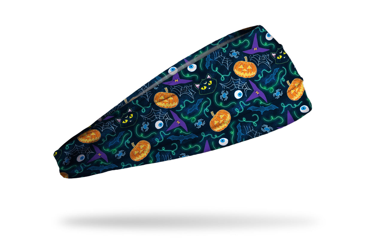 navy headband with repeating pattern of witches hats, cobwebs, spiders, and eyeballs